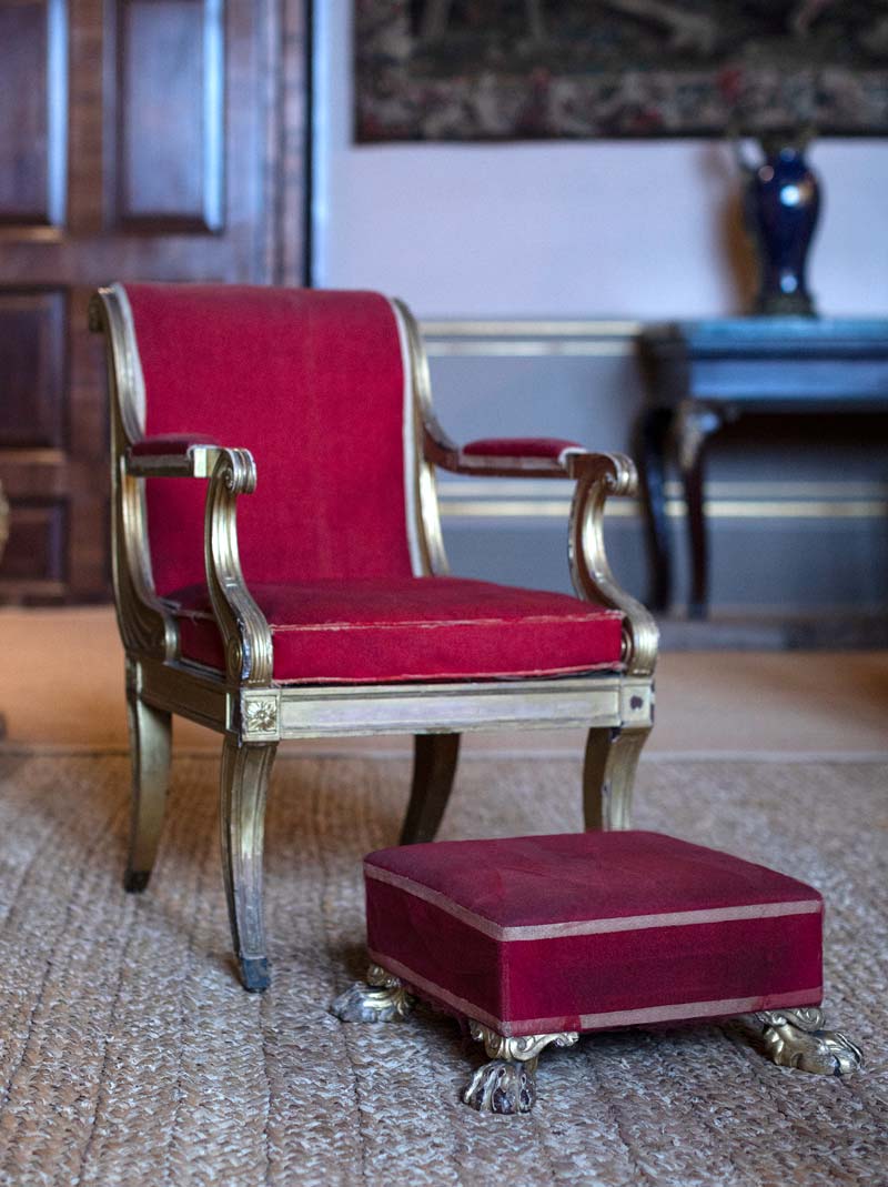 A Regency gilded mahogany open armchair and footstool supplied by Russell, Valance & Evans